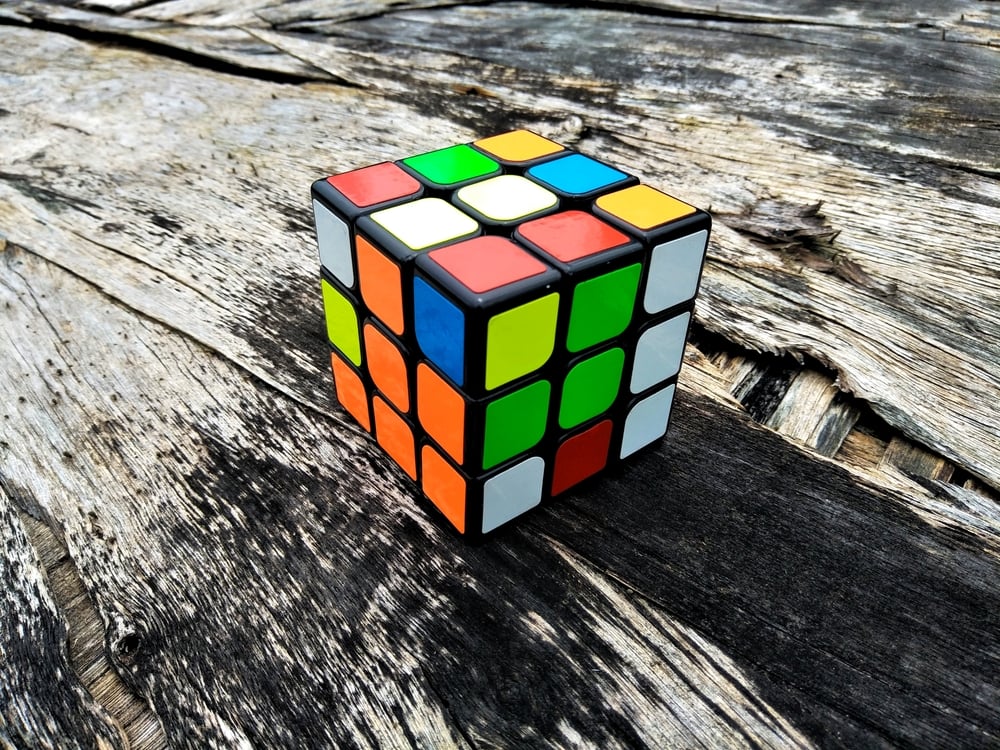 Closeup-Rubiks-cube-on-the-old-wooden-vintage-background.jpg