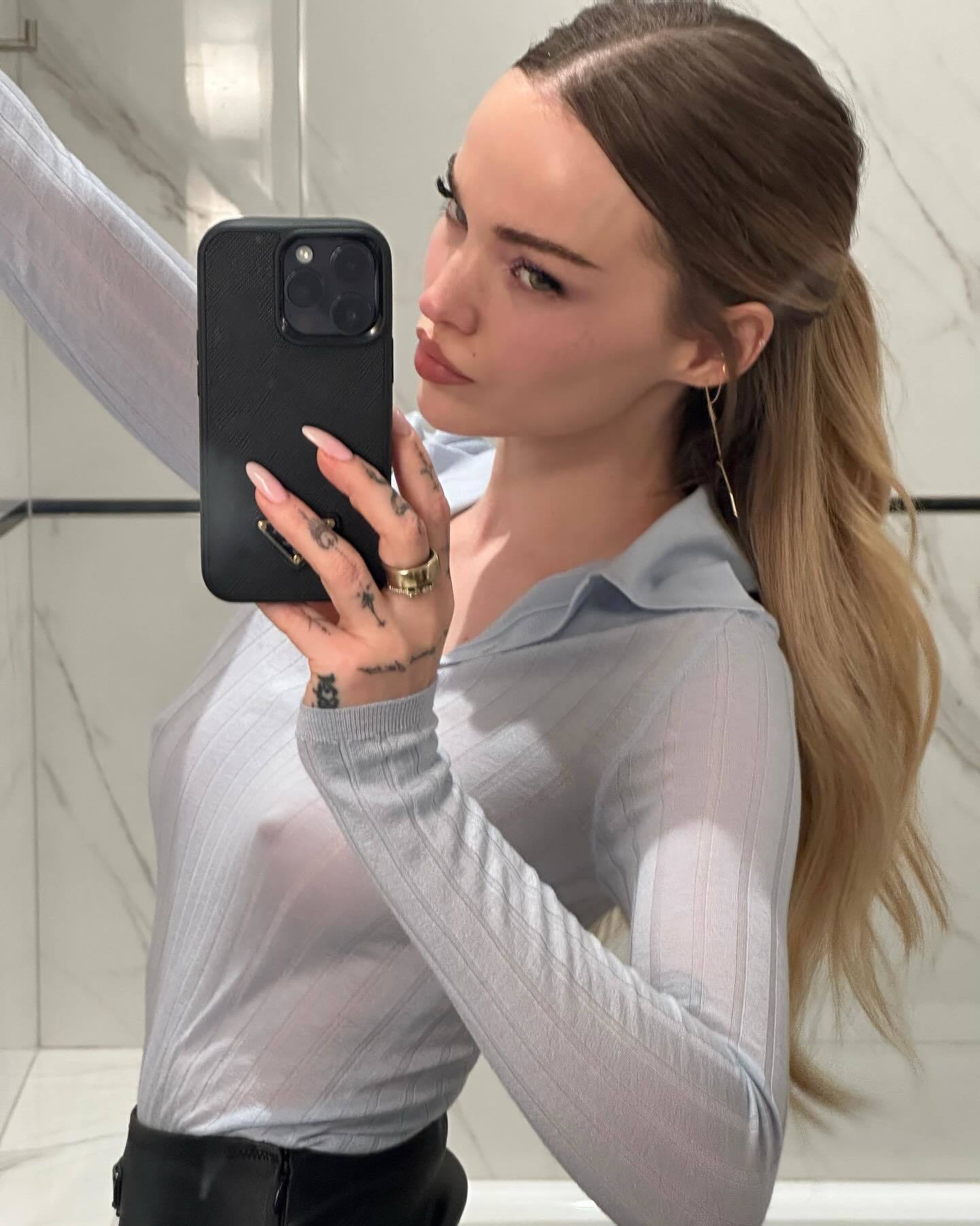 Dove Cameron in a very flimsy top 2.jpg